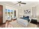 Bedroom boasts tray ceilings, hardwood floors, and bay window seating area with outdoor views at 2636 S Peninsula Dr, Daytona Beach, FL 32118