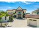 Stately home with a grand facade, barrel tile roof, paver driveway, mature landscaping and large windows at 2636 S Peninsula Dr, Daytona Beach, FL 32118