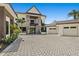 Stunning home with stone accents, a three-car garage, and beautifully paved driveway creating a welcoming and luxurious feel at 2636 S Peninsula Dr, Daytona Beach, FL 32118