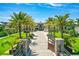 Grand estate featuring a brick driveway lined with mature palm trees and lush landscaping under a bright blue sky at 2636 S Peninsula Dr, Daytona Beach, FL 32118