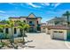 Elegant stucco home featuring a three-car garage, manicured landscaping, and a spacious driveway, blending luxury and comfort at 2636 S Peninsula Dr, Daytona Beach, FL 32118