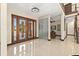 Bright foyer with tile floors, glass block wall feature, and beautiful wooden double-door entrance at 2636 S Peninsula Dr, Daytona Beach, FL 32118