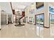 Grand foyer with soaring ceilings, chandelier, tile flooring, and staircase with wooden and metal railings at 2636 S Peninsula Dr, Daytona Beach, FL 32118