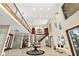 Spacious foyer featuring soaring ceilings, tile flooring, grand staircase with wood and metal railings at 2636 S Peninsula Dr, Daytona Beach, FL 32118