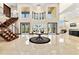Elegant foyer with tile flooring, a decorative rug, a grand staircase, and views of the water at 2636 S Peninsula Dr, Daytona Beach, FL 32118