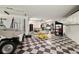 Spacious garage with checkerboard floor, ample storage, and room for multiple vehicles at 2636 S Peninsula Dr, Daytona Beach, FL 32118
