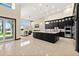 Open-concept kitchen with granite island, black cabinetry, and stainless appliances overlooks living area at 2636 S Peninsula Dr, Daytona Beach, FL 32118