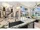 Kitchen with granite countertop island, stainless steel appliances, and custom sink at 2636 S Peninsula Dr, Daytona Beach, FL 32118