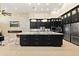 Modern kitchen features an oversized granite island, custom cabinetry, and stainless steel appliances at 2636 S Peninsula Dr, Daytona Beach, FL 32118