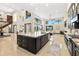 Bright kitchen features a large granite island and is open to the living and dining spaces at 2636 S Peninsula Dr, Daytona Beach, FL 32118