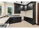 Well-appointed laundry room with black cabinets, granite countertops, and a view of the yard at 2636 S Peninsula Dr, Daytona Beach, FL 32118