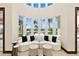 Living room showcasing stylish seating and bay window overlooking a pool and lush landscaping at 2636 S Peninsula Dr, Daytona Beach, FL 32118