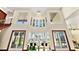 Bright living room with high ceilings, elegant chandelier and view of pool and landscaping at 2636 S Peninsula Dr, Daytona Beach, FL 32118