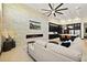 Open-concept living room features a modern fireplace, stone wall, and adjacent kitchen with island at 2636 S Peninsula Dr, Daytona Beach, FL 32118