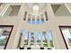 Living room with a view of the pool, backyard and high ceiling with a beautiful chandelier at 2636 S Peninsula Dr, Daytona Beach, FL 32118