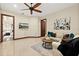 Comfortable living room with a ceiling fan, tv, plush seating and rich wood trim, creating a welcoming space at 2636 S Peninsula Dr, Daytona Beach, FL 32118