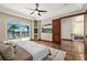 Cozy bedroom boasting a private balcony, water view, and a TV, blending relaxation with modern convenience at 2636 S Peninsula Dr, Daytona Beach, FL 32118