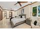 Elegant main bedroom featuring a ceiling fan, tile flooring, a large window, and neutral decor for a serene ambiance at 2636 S Peninsula Dr, Daytona Beach, FL 32118