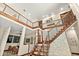 Open staircase with natural wood steps, metal railings, and stone wall, showcasing modern design at 2636 S Peninsula Dr, Daytona Beach, FL 32118