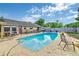 The backyard features a lovely pool, landscaping, a concrete deck, and a wooden fence at 2704 Burgoyne Pl, Deland, FL 32720