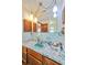 Bathroom with an vintage blue sink and a dark wooden cabinet at 2704 Burgoyne Pl, Deland, FL 32720