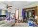 Bedroom with closet, ensuite bath, ceiling fan and lots of visible clutter at 2704 Burgoyne Pl, Deland, FL 32720