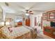 Cozy bedroom featuring a ceiling fan, plush bedding, and ample natural light at 2704 Burgoyne Pl, Deland, FL 32720