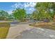Circular driveway leading to a well-manicured property with mature trees and landscaping at 2704 Burgoyne Pl, Deland, FL 32720