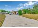 Side view of a single-story home with a long driveway and mature trees at 2704 Burgoyne Pl, Deland, FL 32720