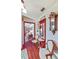 Inviting foyer with wood flooring, vintage decor, and a glimpse into the living spaces at 2704 Burgoyne Pl, Deland, FL 32720