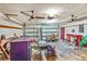 The garage has two ceiling fans, a side door, and plenty of space for storage and hobbies at 2704 Burgoyne Pl, Deland, FL 32720