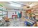 This spacious garage is equipped with ample space for storage, a side door, and two ceiling fans at 2704 Burgoyne Pl, Deland, FL 32720
