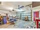 Spacious garage interior featuring two ceiling fans, a side door, and ample room for storage at 2704 Burgoyne Pl, Deland, FL 32720