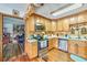 A well-appointed kitchen with wood cabinetry and stainless steel appliances near the living room at 2704 Burgoyne Pl, Deland, FL 32720