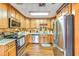 Traditional kitchen featuring wood cabinets and stainless steel appliances at 2704 Burgoyne Pl, Deland, FL 32720
