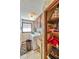 Functional laundry area with washer, dryer, storage cabinet, laundry sink, and floral wallpaper at 2704 Burgoyne Pl, Deland, FL 32720