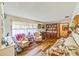 Cozy living room with hardwood floors, floral sofa, and classic furnishings at 2704 Burgoyne Pl, Deland, FL 32720