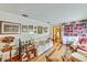 Comfortable living room featuring hardwood floors, floral sofa, and built-in bookshelves at 2704 Burgoyne Pl, Deland, FL 32720