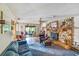 Inviting living room featuring a stone fireplace, comfortable seating, and natural light at 2704 Burgoyne Pl, Deland, FL 32720