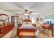 Spacious main bedroom with a ceiling fan, wood furniture, and neutral decor at 2704 Burgoyne Pl, Deland, FL 32720
