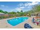 Relax by the refreshing pool surrounded by lush landscaping and a wooden fence at 2704 Burgoyne Pl, Deland, FL 32720