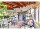 Screened porch showcasing comfortable seating, ceiling fan, and view of the well maintained backyard at 2704 Burgoyne Pl, Deland, FL 32720