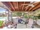 Relaxing screened porch features a wooden ceiling, ceiling fan, comfortable seating, and view of the pool at 2704 Burgoyne Pl, Deland, FL 32720