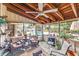 Spacious screened porch with a wooden ceiling, ceiling fan, comfortable seating, and overlooking the backyard pool at 2704 Burgoyne Pl, Deland, FL 32720