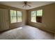 Bedroom featuring neutral walls, tile flooring, two windows, and a ceiling fan at 288 Mcmillon Dr, Orange City, FL 32763