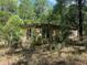 Exterior of home featuring windows and overgrown landscaping at 288 Mcmillon Dr, Orange City, FL 32763