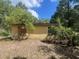 Exterior of home featuring boarded window and overgrown landscape at 288 Mcmillon Dr, Orange City, FL 32763