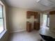 Kitchen featuring minimal cabinetry, tile flooring, and access to utility room at 288 Mcmillon Dr, Orange City, FL 32763