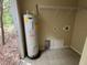 Utility room with water heater, shelving and tile floors at 288 Mcmillon Dr, Orange City, FL 32763