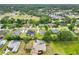An aerial view of a neighborhood showcasing well-maintained homes, green spaces, and mature trees at 2940 Se 23Rd Ave, Ocala, FL 34471